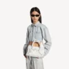 Bolso Le City para mujer, pequeño, con tachuelas gigantes y pedrería en blanco óptico Bolso Le City para mujer, pequeño, con tachuelas gigantes y pedrería en blanco óptico