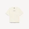 Camiseta de mujer Balenciaga con diseño en la espalda, corte medio, en color crema