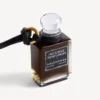 Colgante con frasco de perfume en miniatura en color negro