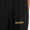 Pantalones de chándal holgados para hombre con diseño de spray desordenado en negro